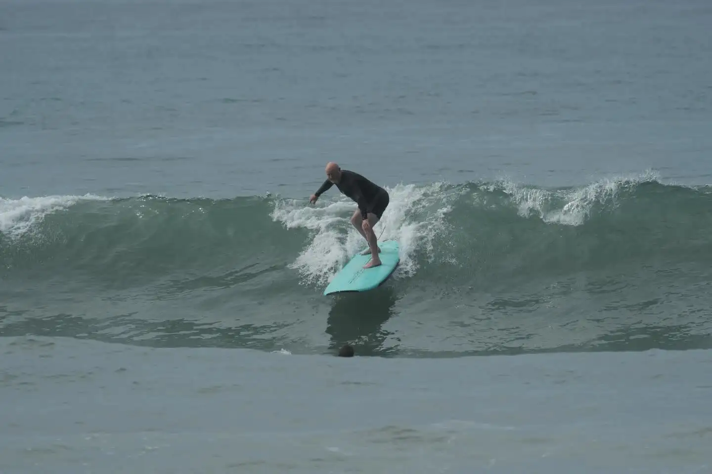 Surfer riding a green wave in Santa Teresa